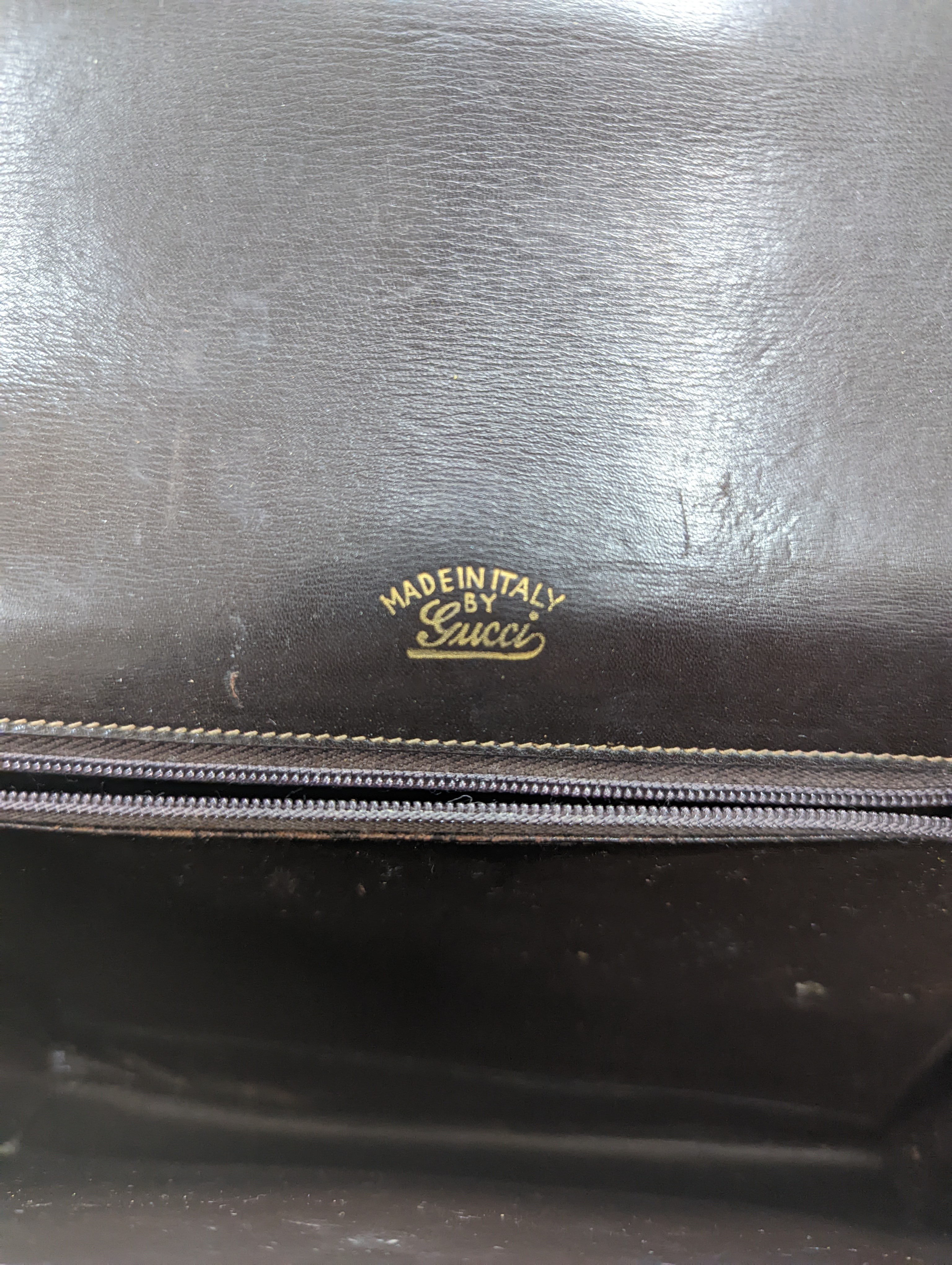 A vintage brown leather handbag stamped 